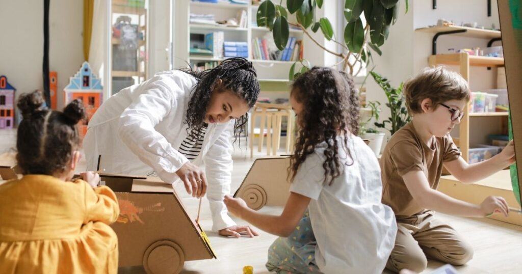 Homeschool child working on a hands-on project at the kitchen table with books, art, and science materials—embracing a relaxed, interest-led daily rhythm